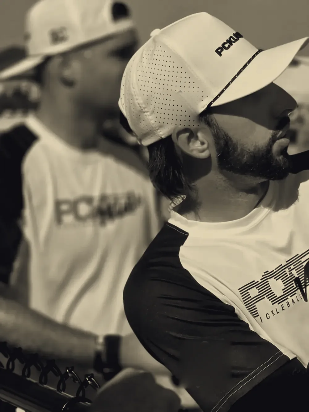CourtFlo player wearing a CourtFlo cap and CourtFlo sleeve courtside at a pickleball event